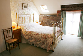 Spacious, light and airy double bedroom boasting a Victorian brass bed